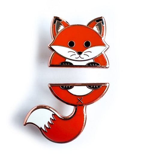 Two enamel pins that come together to form a fox that is cut in half. The top pin is the foxes head and front feet. The bottom pin is the fox's tail and back feet.