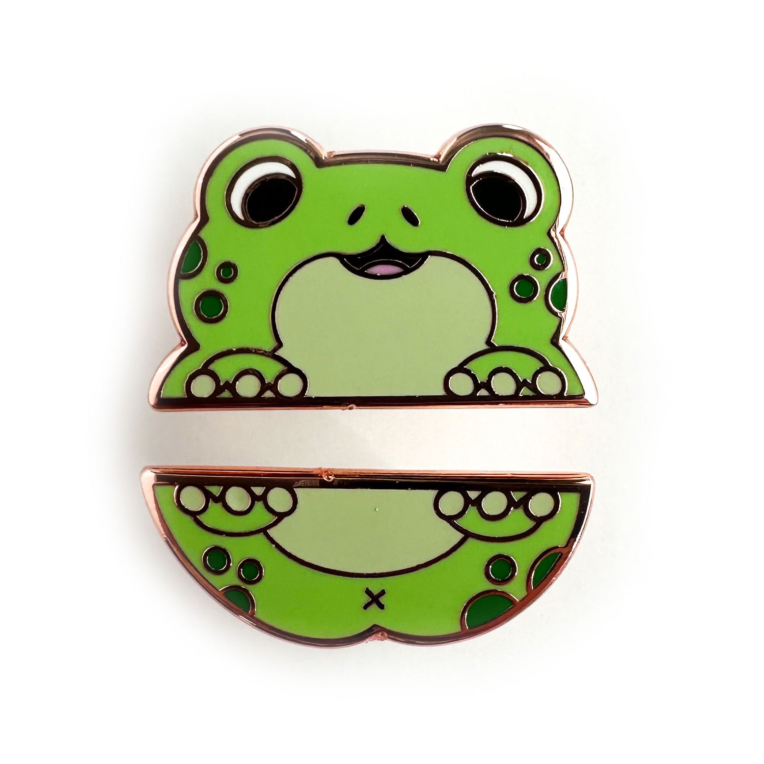 Two enamel pins that form the top and bottom half of a cute cartoony green frog with dark green spots. 