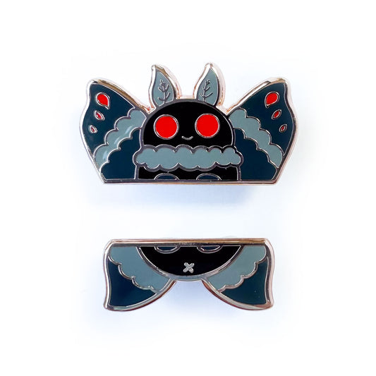 Two enamel pins that come together to form Mothman, one half is the head and wings, the other is the bottom wings and butt. 