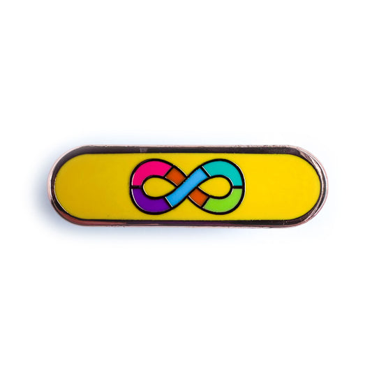 A capsule shaped enamel pin with the motifs of the Autistic Pride Flag on it, a rainbow infinity symbol on a gold background. 