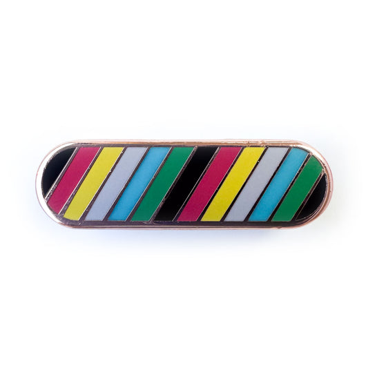 A long oval shaped pin with diagonal stripes of the colors of the Disability Pride flag.