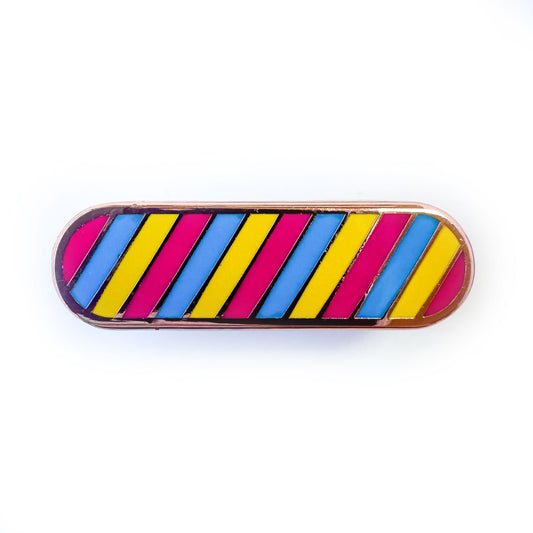 A capsule shaped pin with diagonal stripes in the colors of the Pansexual pride flag, hot pink, blue and yellow. 
