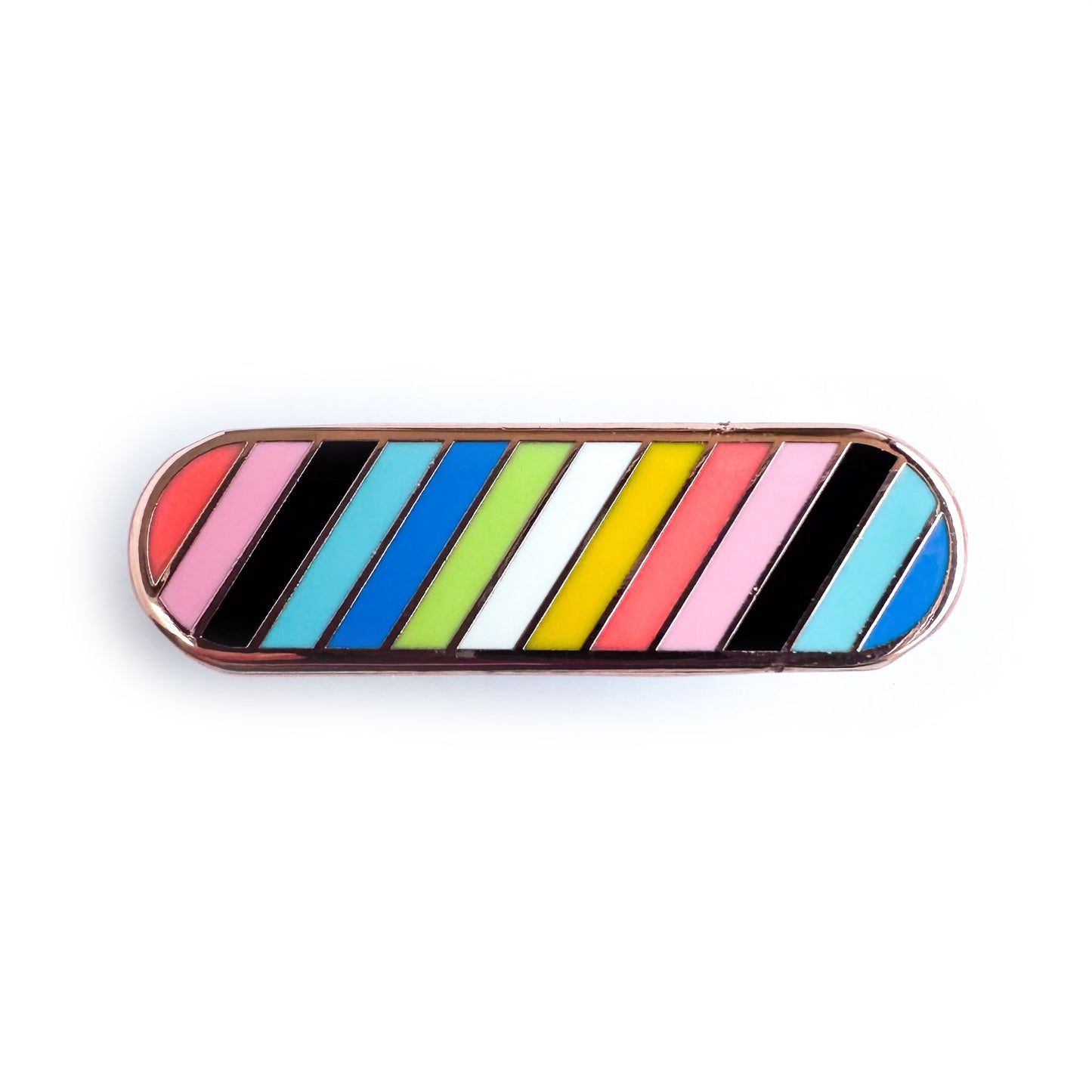 A capsule shaped enamel pin with the colors of the Queer Pride Flag in diagonal stripes.