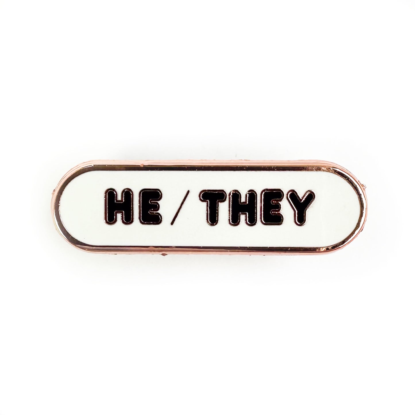 A white oval with black bubble letters that reads "He/They".
