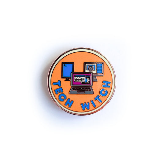 A circular merit badge style pin with the words "Tech Witch" on it. There are images of a laptop surrounded by two computer monitors on it. The pin is orange with a yellow border and blue words.