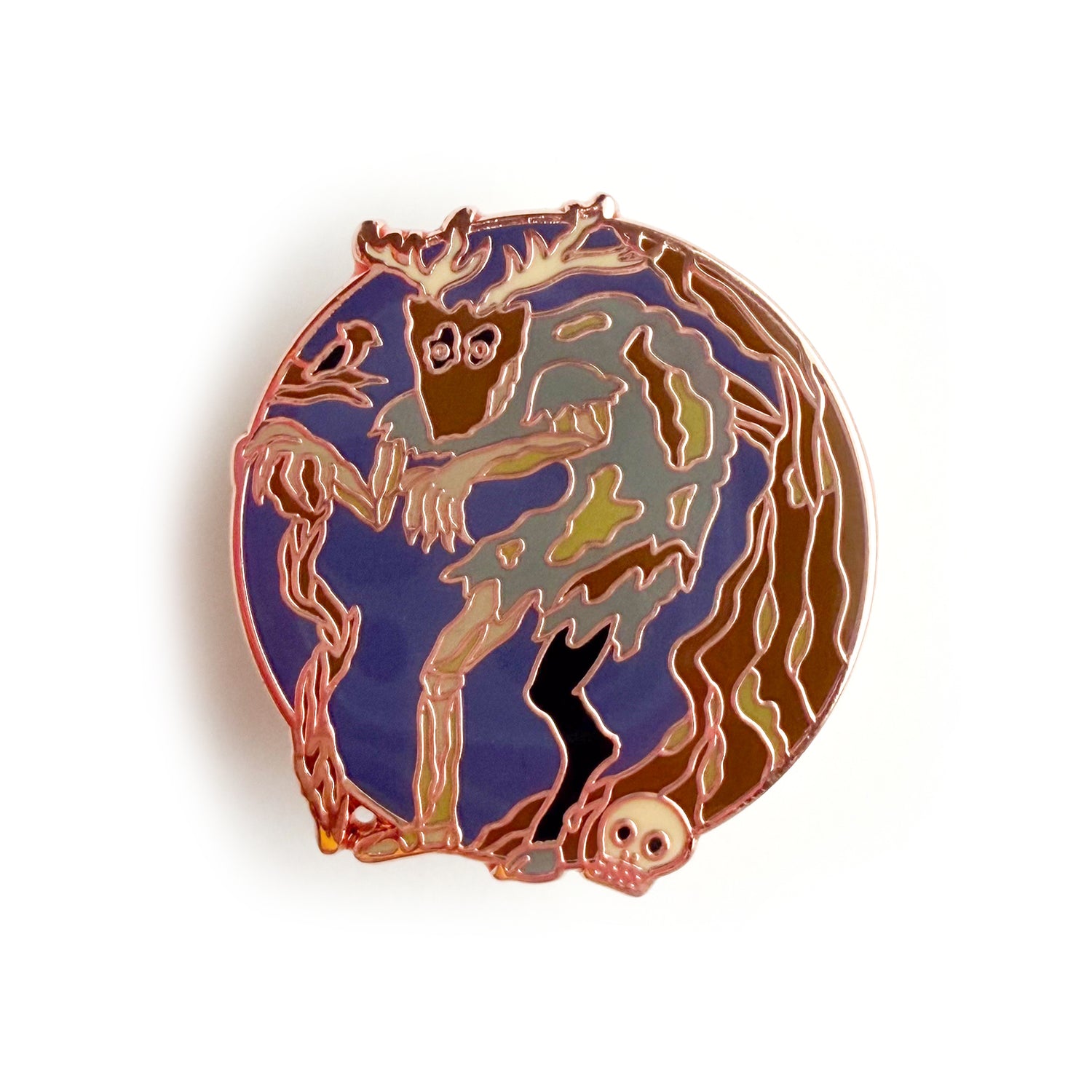 An enamel pin in the shape of a circle with a hunched zombie like creature with a goat leg and a mask with antlers standing near a tree and a skull. There is a bird in a brand next to the creature. 