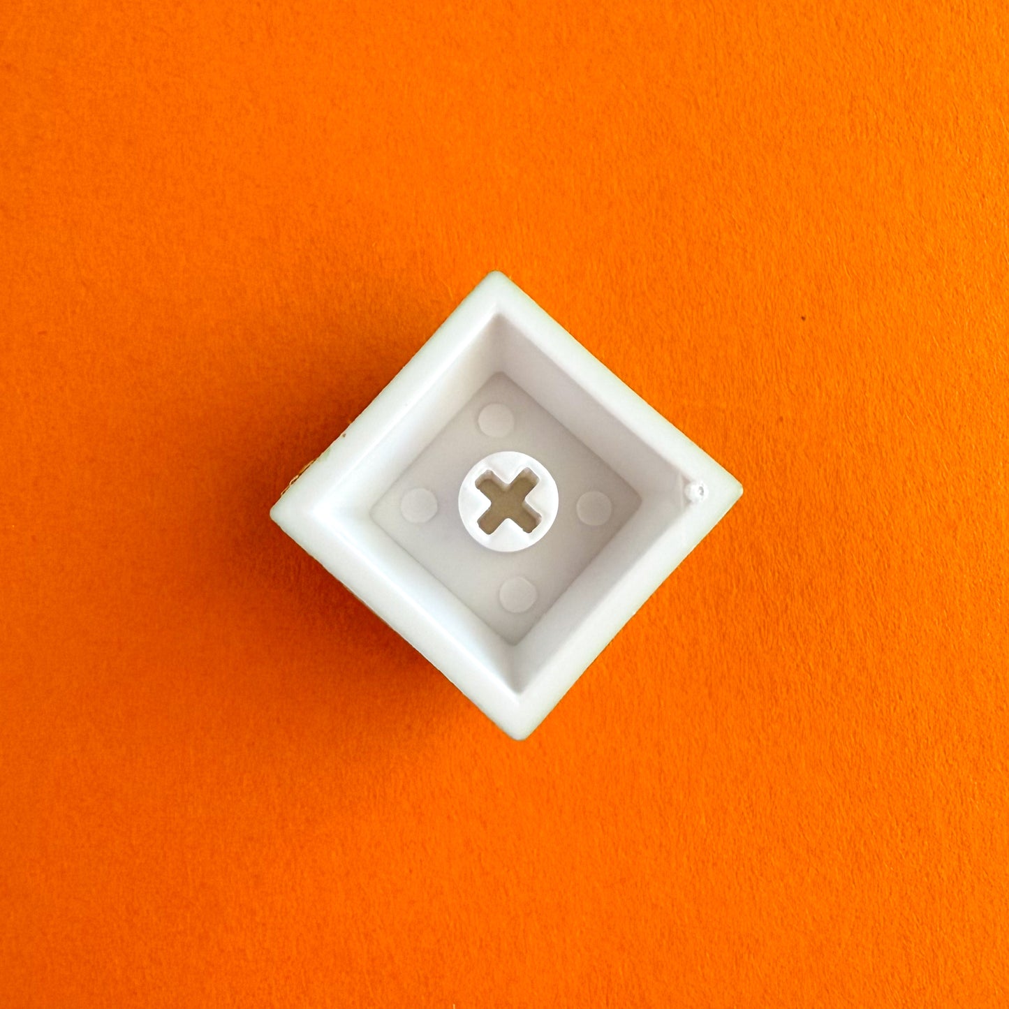 And upside down keycap on an orange background. 