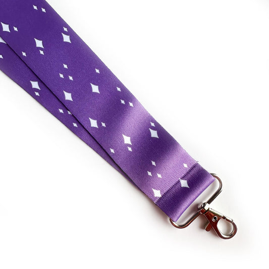 A purple lanyard with white sparkle illustrations on it.