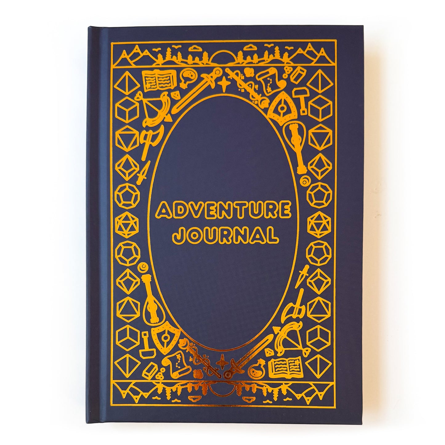A dark blue hard cover notebook  with gold foil details. The title Adventure Journal in the center, surrounded by DND and fantasy themed illustrations. A few examples of these are dice, swords, potion bottles, lutes, and wands. There is a mountainous landscape along the top and bottom of the book. 