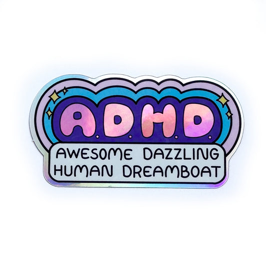 A holographic vinyl sticker with pink bubble letters that read "A.D.H.D." surrounded by bubbles in blue and lavender and sparkles. Below this are the words "Awesome Dazzling Human Dreamboat"