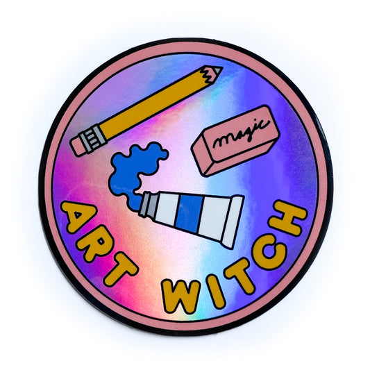 A circular holographic sticker that reads "Art Witch" in bubble letters with illustrations of a tube of blue paint, a yellow pencil and a pink eraser that reads "magic". 