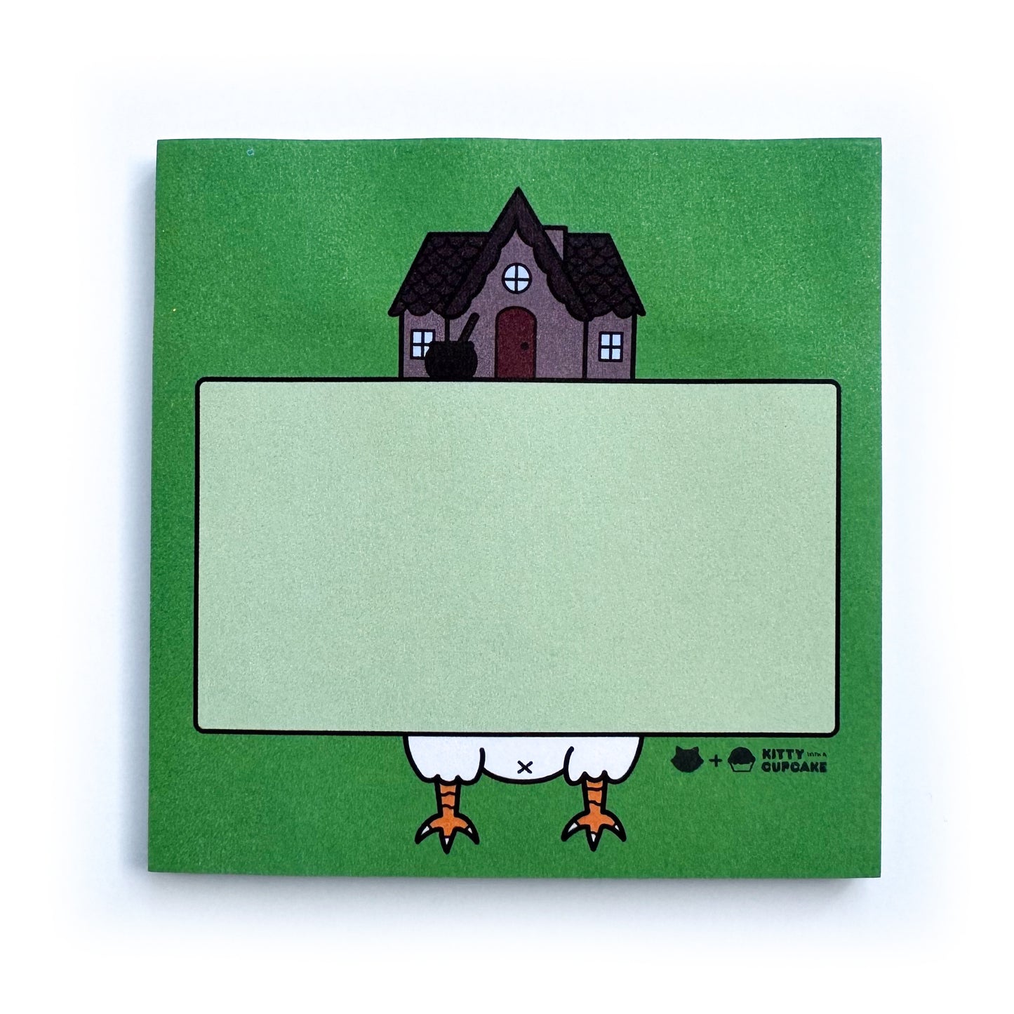 A square pad of green sticky notes featuring an illustration of Baba Yaga's hut surrounding a light green box which is an area to write in. 