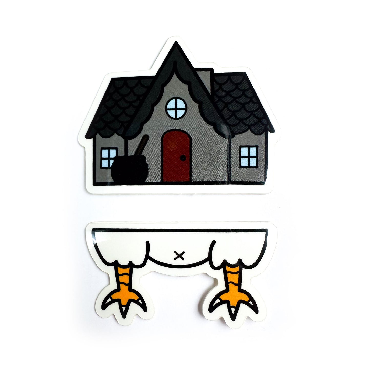 Two vinyl stickers that come together to form Baba Yaga's house. The top sticker is a grey house with a peaked roof and a cauldron outside. The bottom sticker is a chicken butt with legs. 