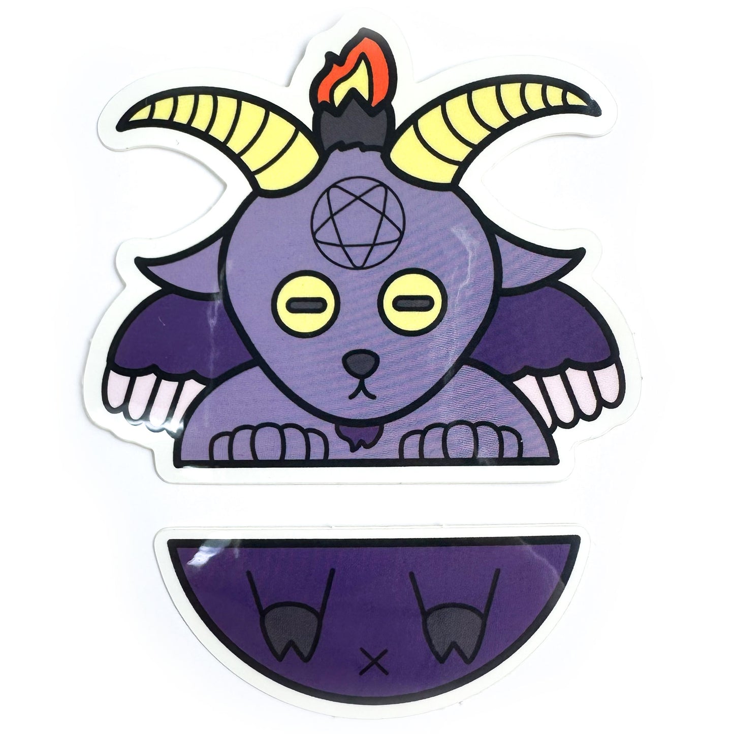 Two stickers in a set that come together to form Baphomet that looks like he has been cut in half horizontally across the middle. The top half is his goat head with wings and the bottom half is his little goat legs and butt. 