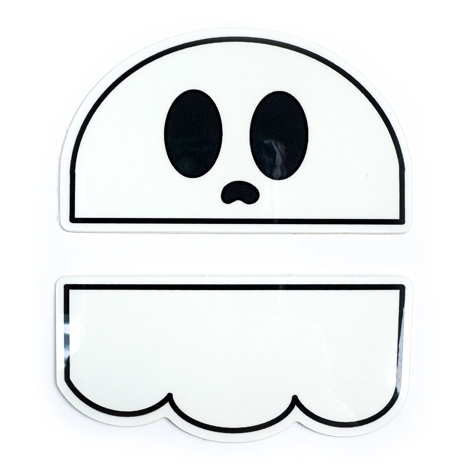 Two stickers that come together to form an illustration of a cute ghost with big eyes and a little frown mouth. 