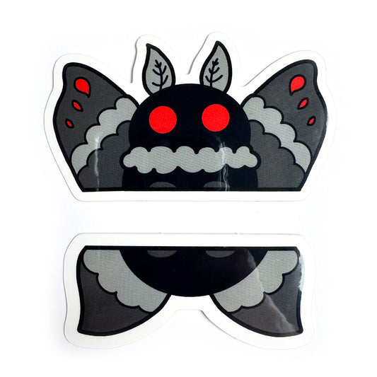 A pair of stickers that come together to form the top and bottom half of Mothman illustrated in a cartoony style with grey wings, a black body, and big red circle eyes.