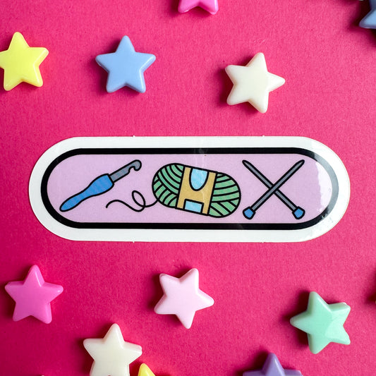 A sticker with illustrations of knitting and crochet supplies. The sticker is on a hot pink background with pastel stars around it.