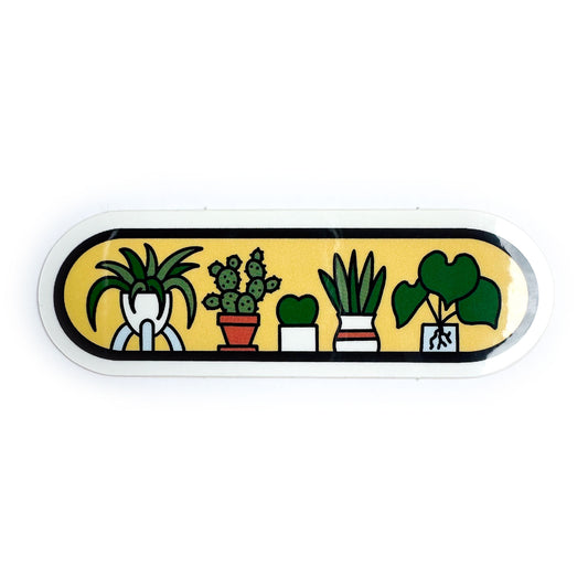 A yellow oval sticker with cartoony illustrations of houseplants on it.