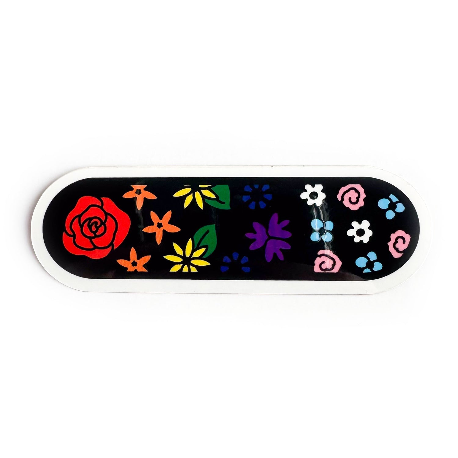 An oval shaped sticker with a black background with illustrations of flowers on it. The flowers are the colors of the rainbow pride and trans pride flags. 