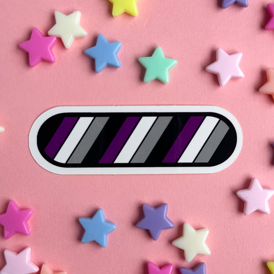 A sticker in the shape of an oval in the colors of the Asexual pride flag. The sticker is on a pink background with star beads around it.