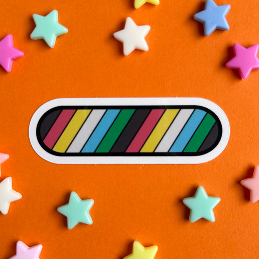 An oval shaped sticker in the colors of the Disability Pride flag on an orange background with pastel stars around it.