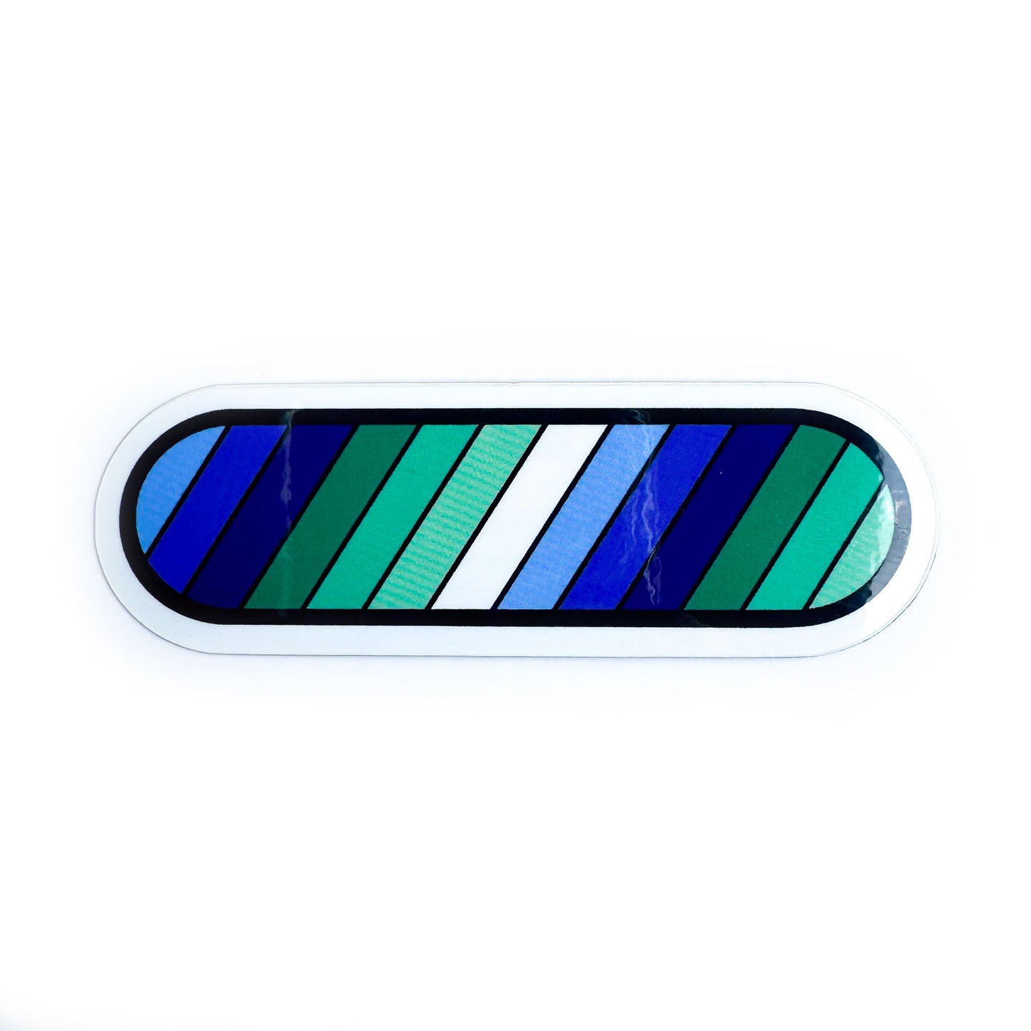 A capsule shaped vinyl sticker with diagonal stripes in the colors of the gay or Vincian pride flag. 