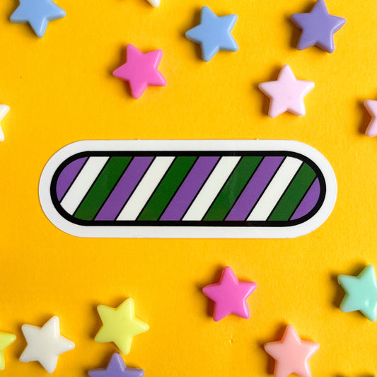 A capsule shaped sticker with diagonal stripes of the colors of the Genderqueer Pride Flag, purple, white and green. The sticker is on a yellow background with pastel stars around it.