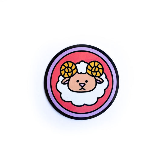 A circular sticker with a cute sheep on it to symbolize the Aries zodiac sign.