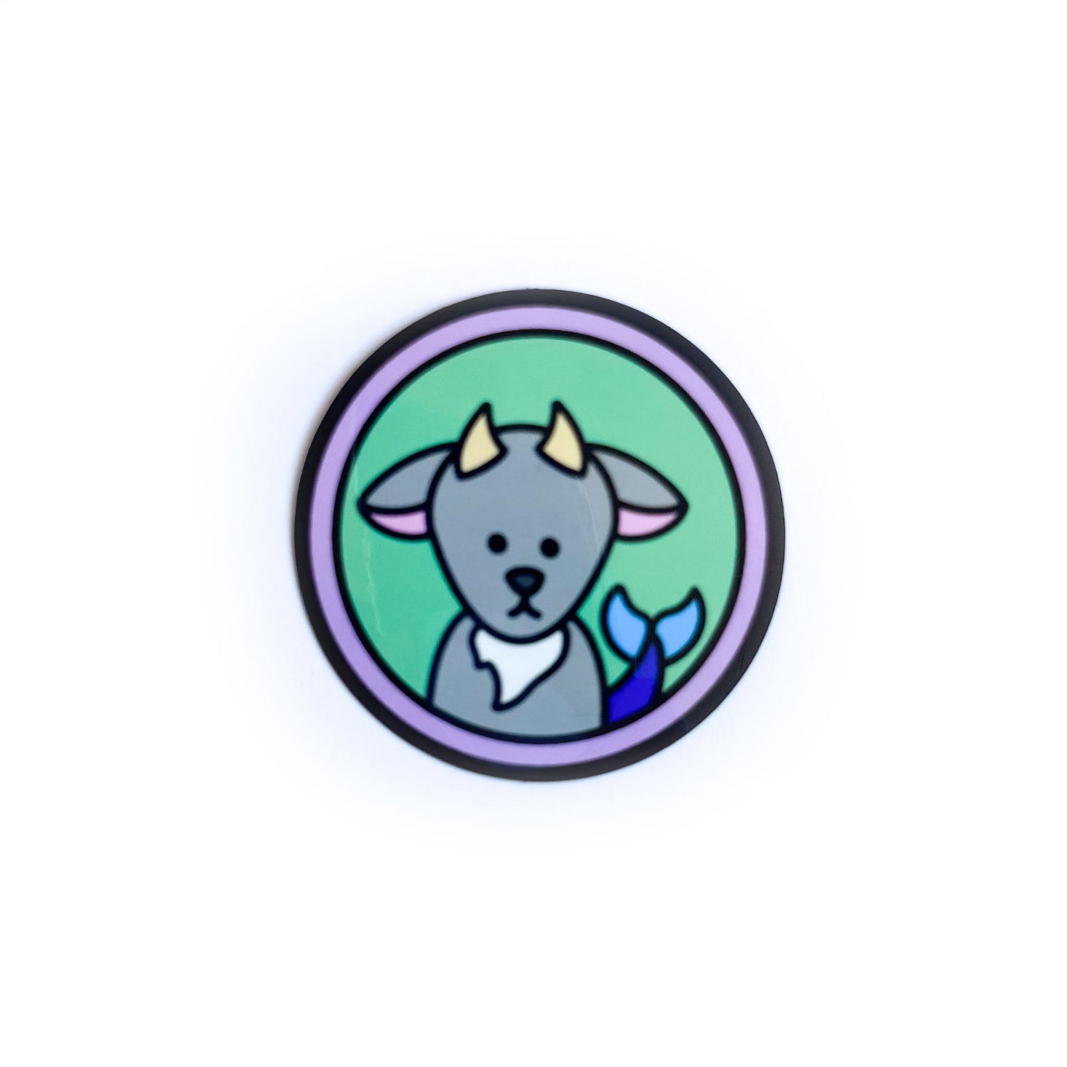 A circle sticker with a cute illustration of a sea goat on it representing the Capricorn zodiac sign.