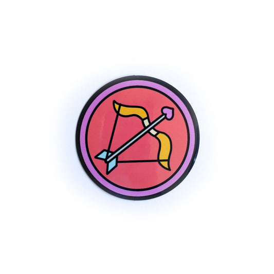 A sticker of a red circle inside a pink border with a cute bow and arrow inside the red circle to represent the Sagittarius zodiac sign.