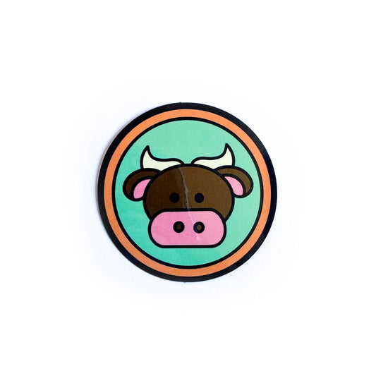 A circle sticker with a cute illustration of a bull on it to represent the Taurus zodiac sign.