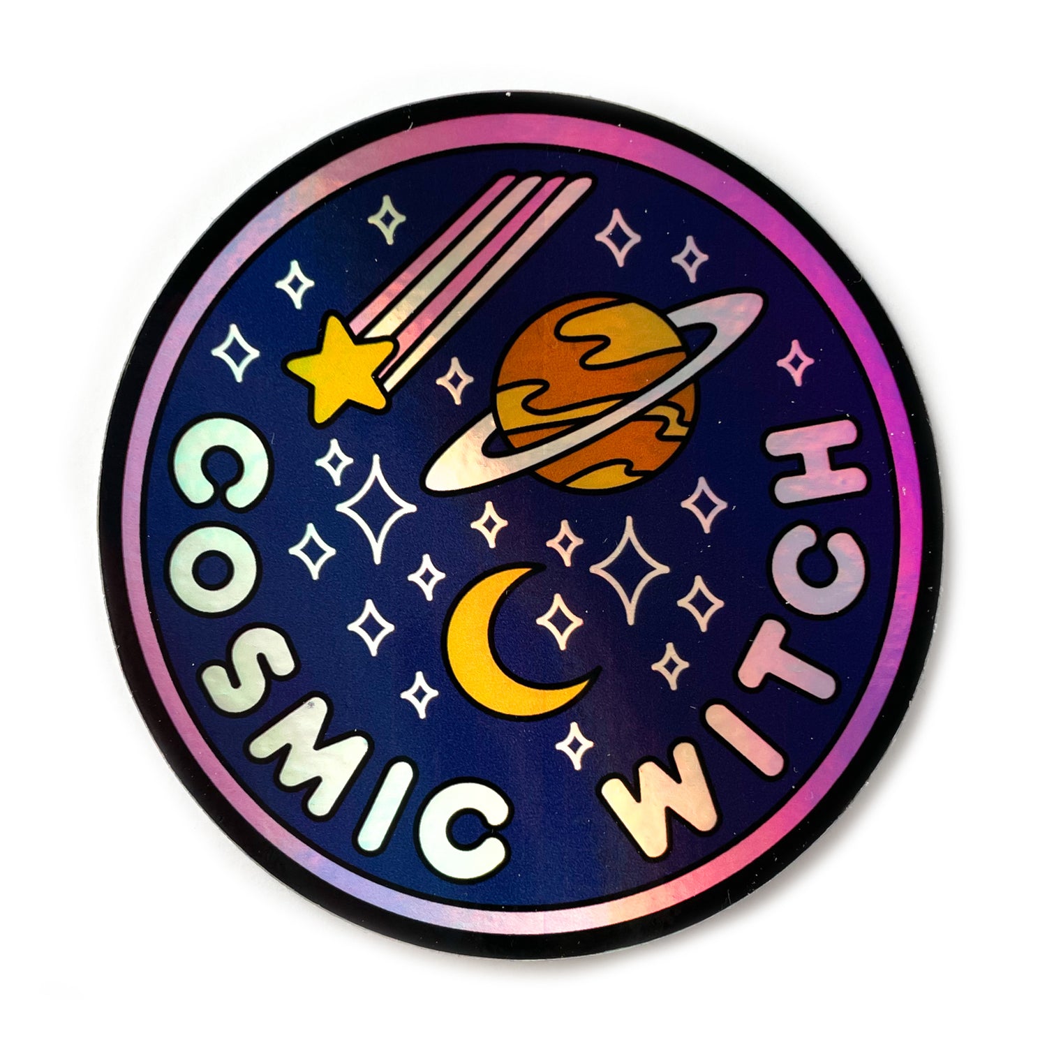 A circular holographic sticker. It has a hot pink border and a dark blue background with light pink words that read "Cosmic Witch". Depicted above the words are a crescent moon, sparkle stars, a shooting star, and the planet Saturn. 