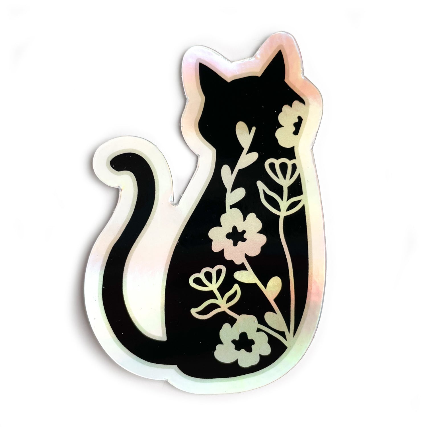 A holographic sticker in the shape of a silhouette of a black cat. There are floral vines along the back of the cat.