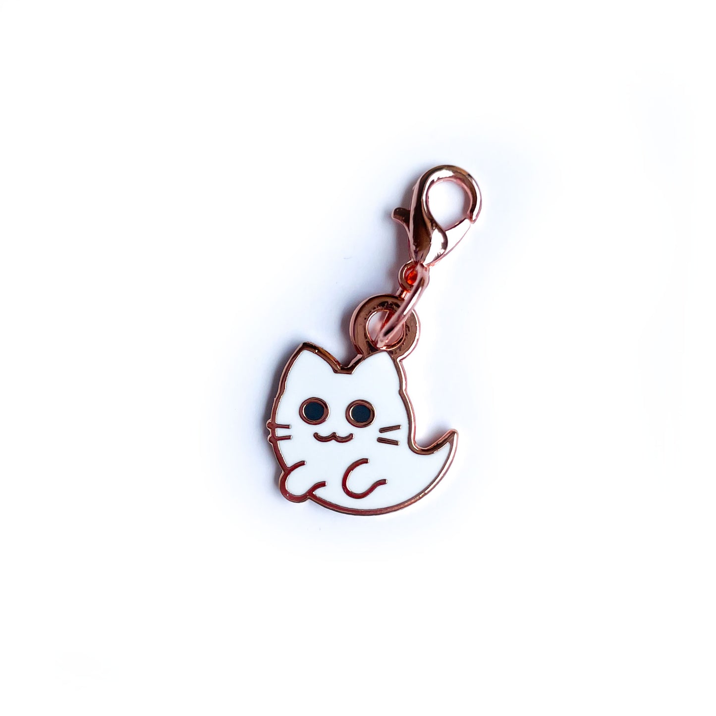 A lobster claw clasp charm shaped like a cute kitty ghost with whiskers. 
