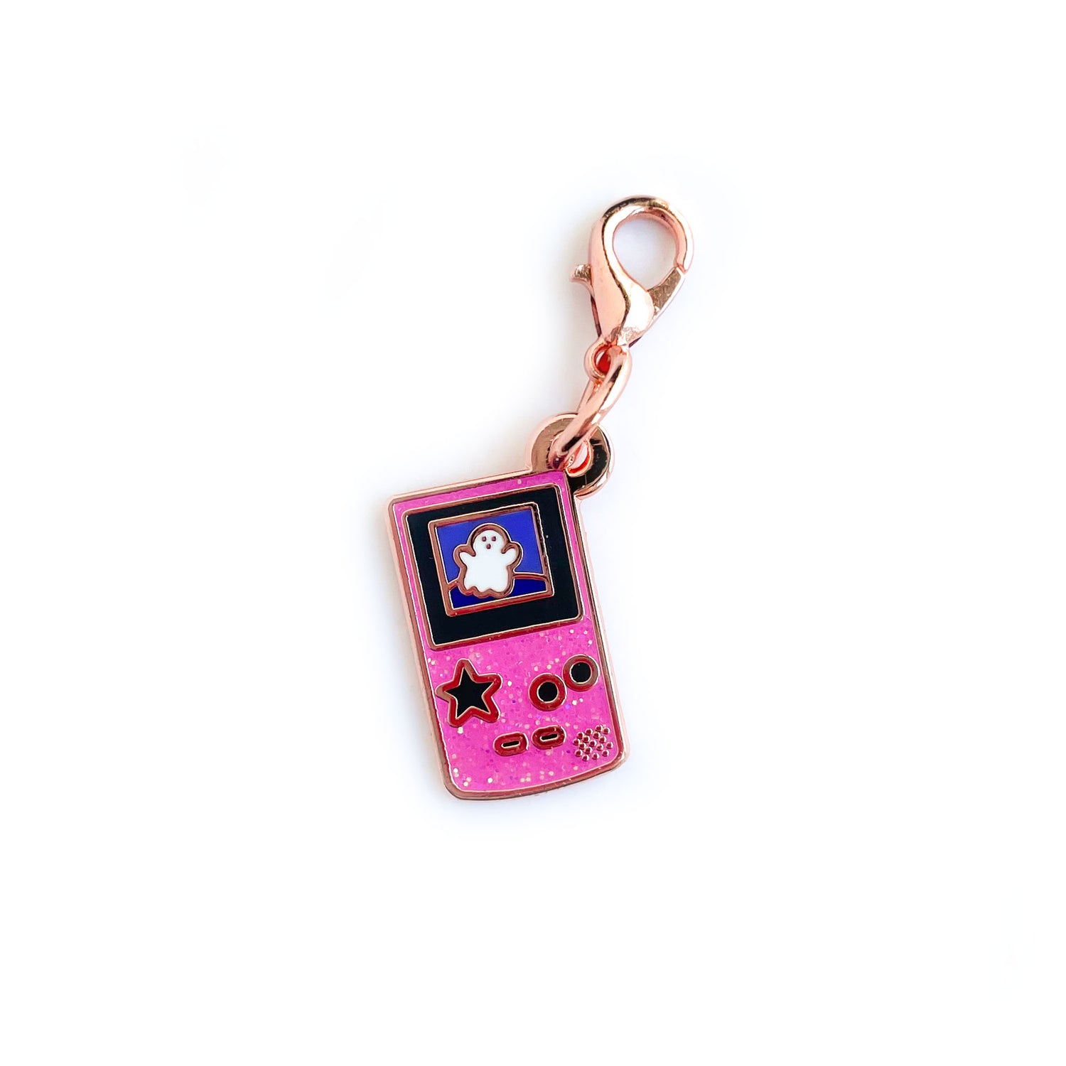 A lobster claw clasp charm that is the shape of a pink glitter Game Boy with a star button and a cute ghost on the screen. 