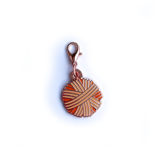 An orange yarn ball lobster claw clasp charm.