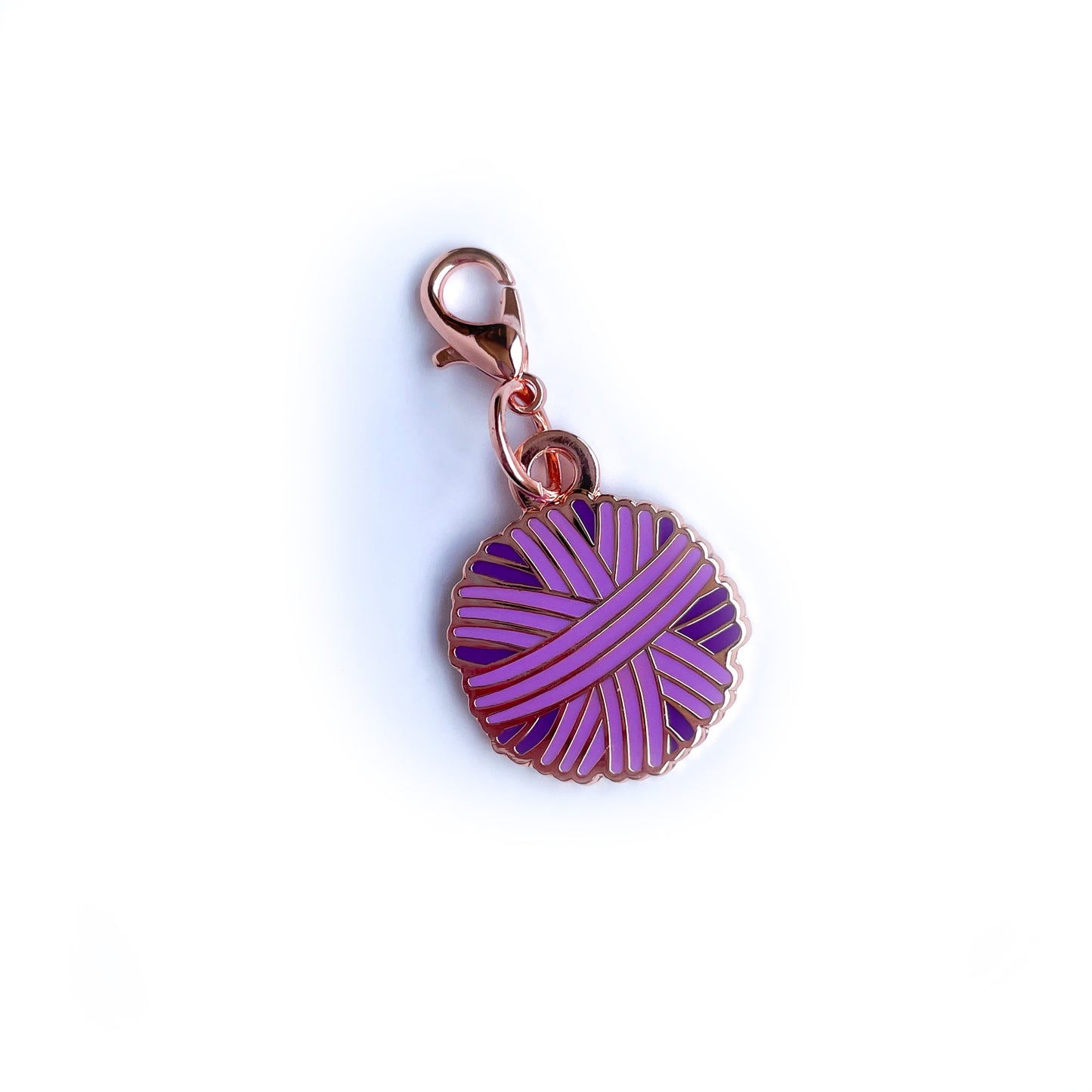 A purple yarn ball shaped lobster claw clasp charm.