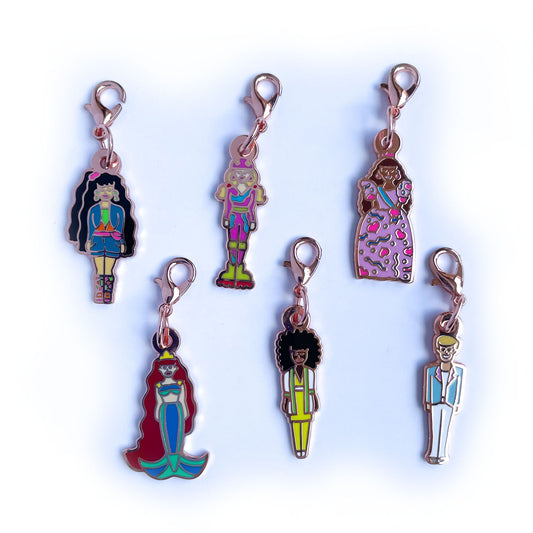 Six doll shaped lobster claw clasp charms