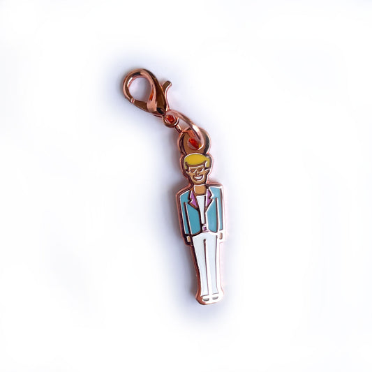 A lobster claw clasp charm shaped like a Ken doll