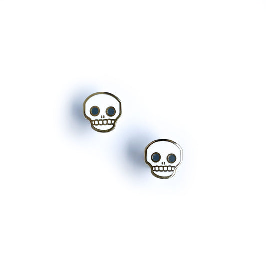 Stud earrings shaped like skulls.