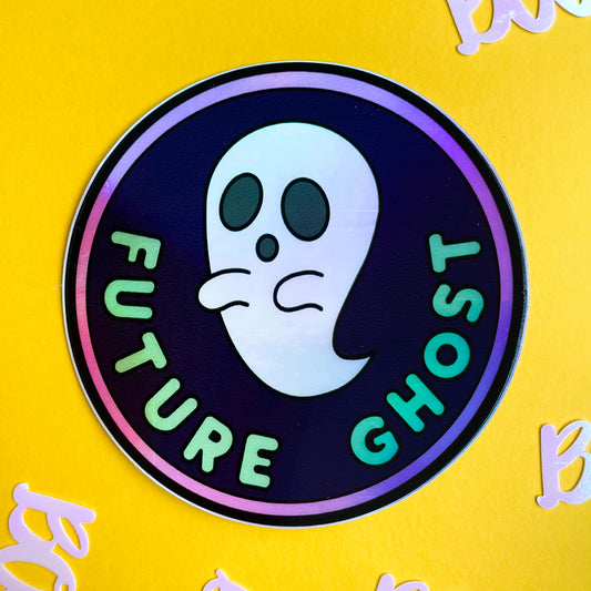 A circular holographic sticker that reads "Future Ghost" with a ghost on it on a yellow background.