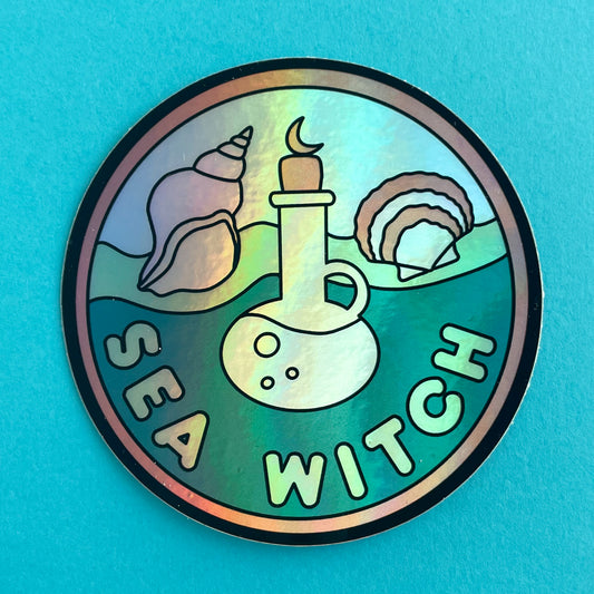 A circular holographic sticker with a salmon border the words "Sea Witch" on it. It has a potion bottle with sea shells and waves in the background. The sticker is on a light blue background.