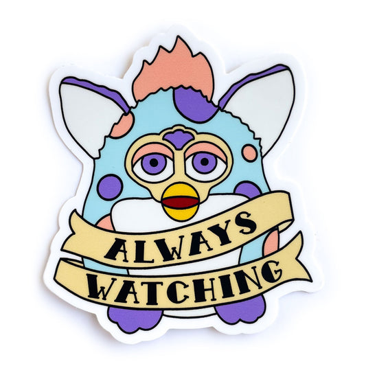 A sticker of a furby that is pastel blue with peach and purple spots. There is a tattoo style banner around him that says. "Always Watching"