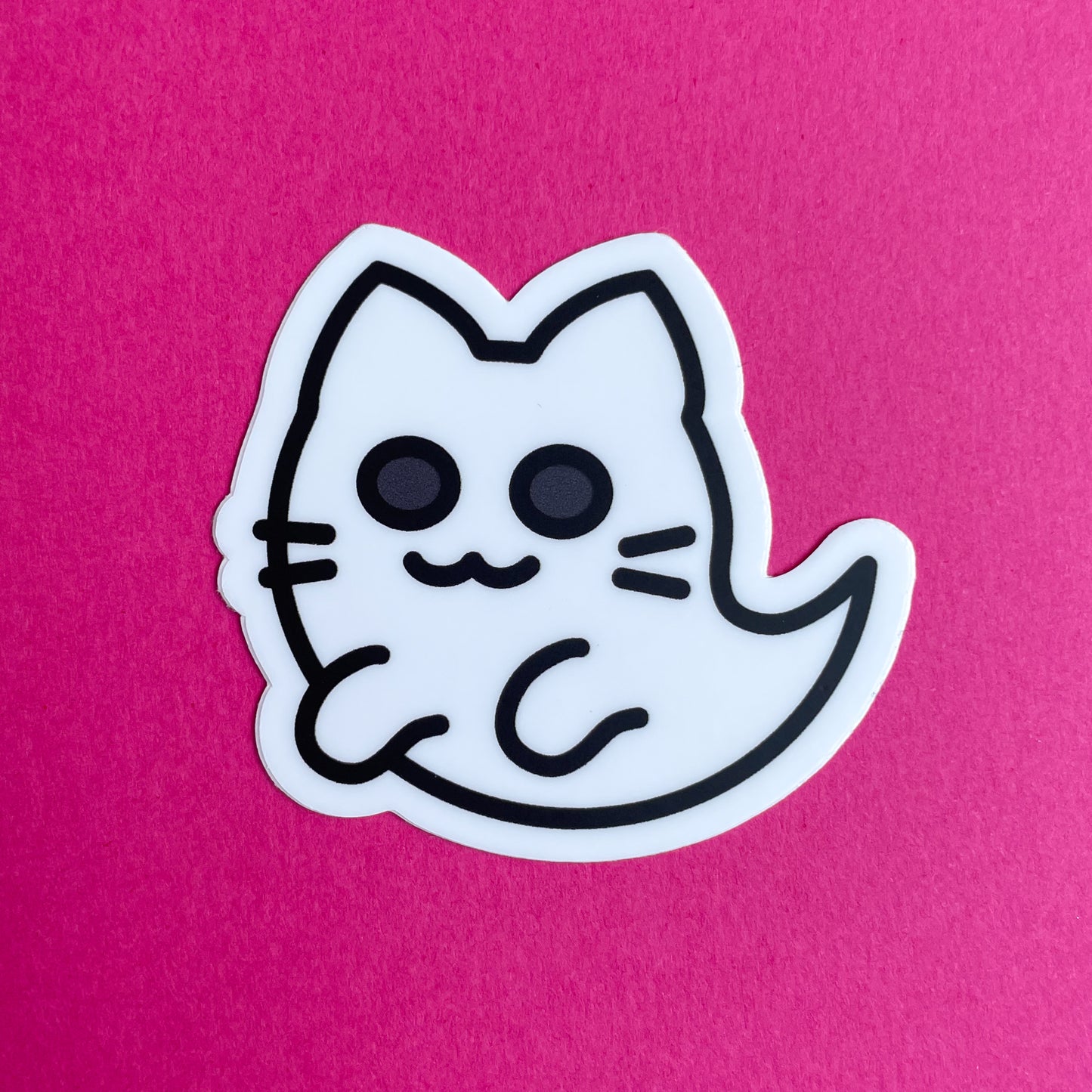 A sticker of a cute ghost cat on a pink background.