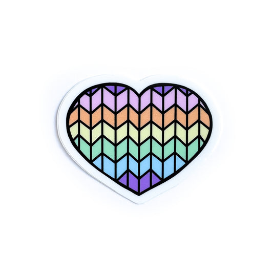A heart shaped vinyl sticker with a pastel rainbow stockinette stitch pattern on it.