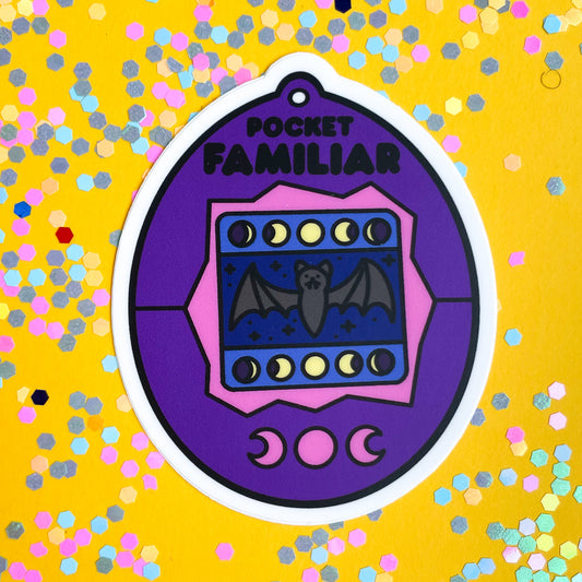 A purple virtual pet shaped sticker on a yellow background covered in pastel confetti.