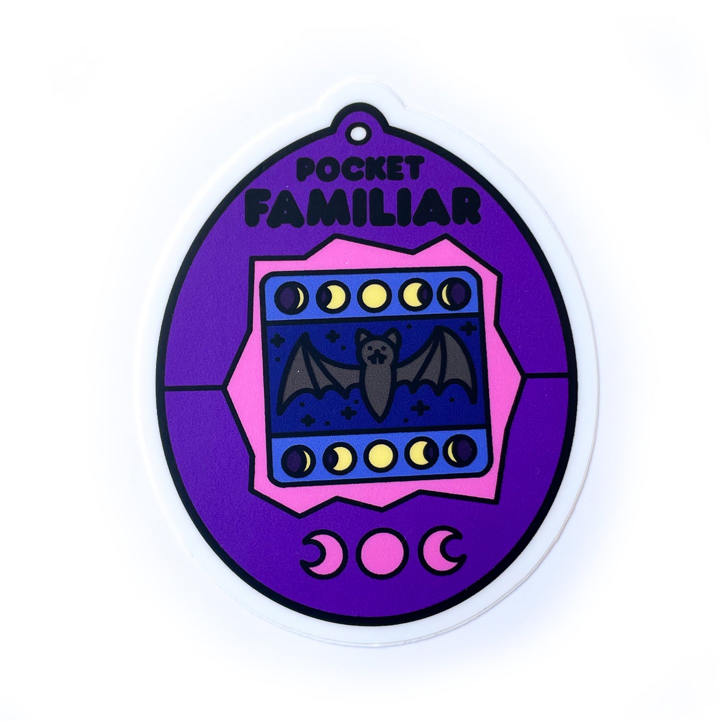 A vinyl sticker shaped like a virtual pet that is purple with a bat on the screen. 