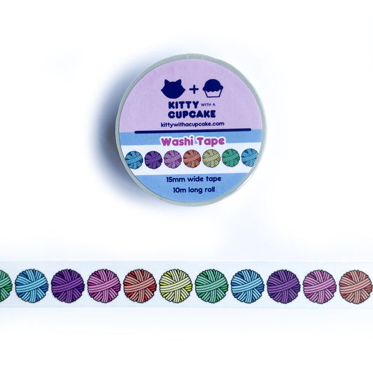 A roll of washi tape above a sample of the washi tape that is a white background with pastel rainbow yarn balls on it.